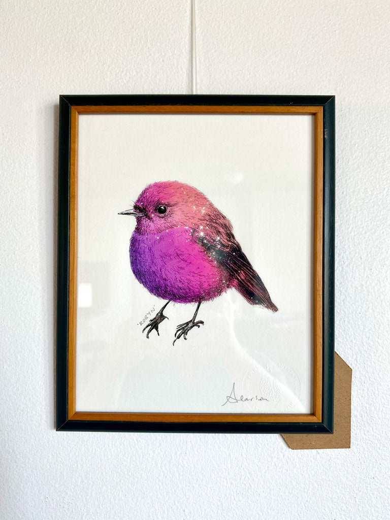 Framed artwork of a pink bird on a white background